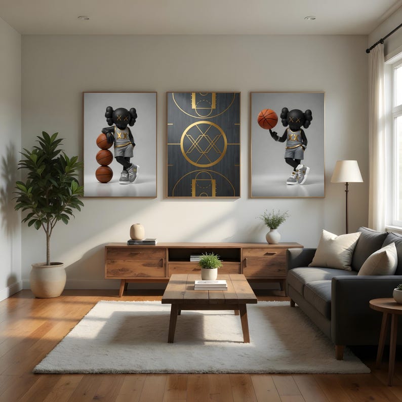 May include: Three framed art prints featuring a basketball theme. One print shows a black figure with a basketball, another a basketball court design, and the last a figure with a basketball. The prints are displayed in a living room setting.