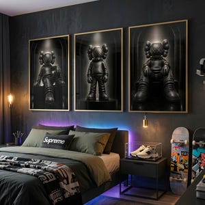 May include: Three framed wall art prints featuring black KAWS-style character figures in a dark, spotlighted setting. The figures are depicted in different poses, including sitting and standing, set against a deep black background with gold frames.