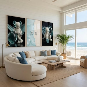 May include: A curved white sofa with blue throw pillows sits before a wooden coffee table. Three large wall art prints hang above the sofa, featuring stylized white figures with X-shaped eyes and blue translucent spheres against dark backgrounds.