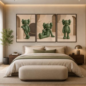 May include: A set of three framed wall art prints featuring olive green cartoon figures with X-shaped eyes. Each print displays a different pose of the same character against a neutral beige background with geometric shapes and soft lighting.