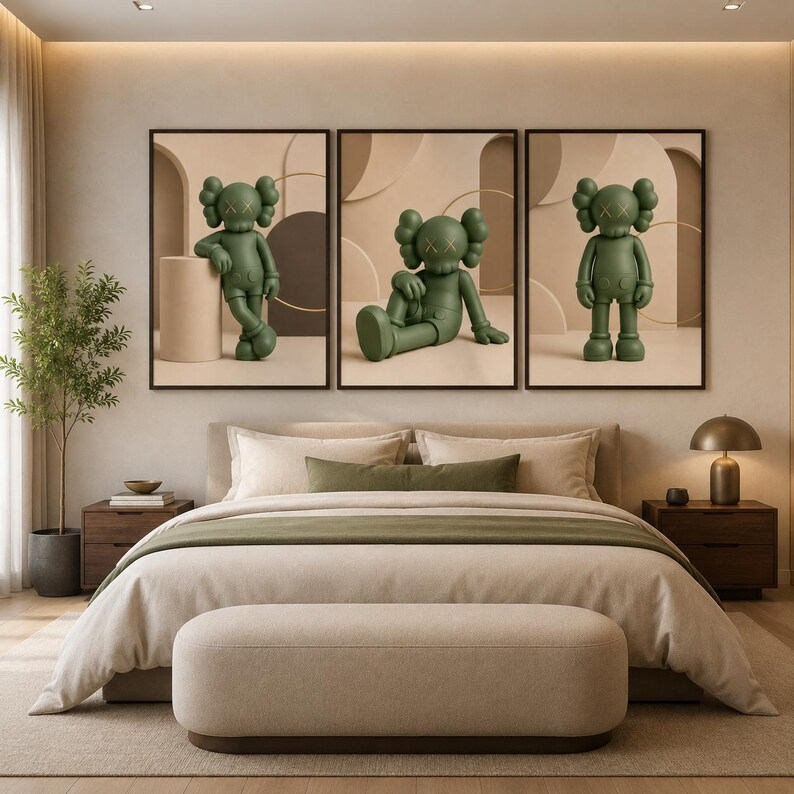 May include: A set of three framed wall art prints featuring olive green cartoon figures with X-shaped eyes. Each print displays a different pose of the same character against a neutral beige background with geometric shapes and soft lighting.