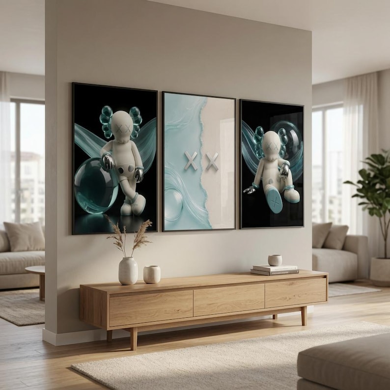 May include: A set of three framed wall art prints featuring a stylized white character with X-shaped eyes and silver accents. The outer prints show the character against a black background with teal swirls, while the center print displays a light blue wave.