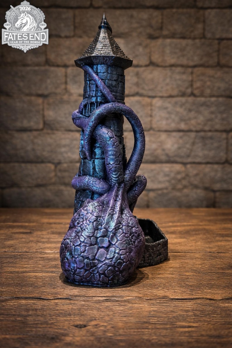 May include: A dark purple and black dice tower shaped like a stone lighthouse wrapped in tentacles. The structure features a textured, scaly surface and a base with a tray for dice. The top of the tower has a pointed roof, and the logo FATES END 2026 YEAR OF THE HORSE is visible in the upper left corner.
