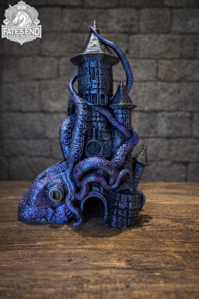 May include: A dark purple and blue 3D printed tower sculpture featuring a large octopus with a prominent eye wrapped around the stone-textured structure. The top of the tower displays a logo with a unicorn and the text FATES END YEAR OF THE HORSE 2026.