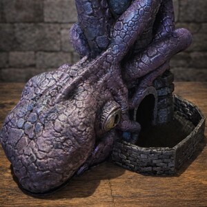 May include: A purple and blue textured octopus sculpture with a large eye, coiled tentacles wrapping around a stone-like tower structure, and a small hexagonal stone-walled base. The logo FATES END 2026 YEAR OF THE HORSE is visible in the corner.