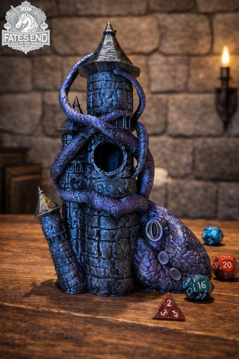 May include: A dark stone tower dice tower featuring a large purple tentacle wrapped around the structure, with a circular opening in the center and a textured base. Several multi-sided gaming dice are positioned near the base of the tower.