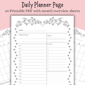 May include: A black and white printable daily planner page with floral accents. The page includes sections for the date, focus, water intake, and to-do lists. The text "Daily Planner Page" and "a5 Printable PDF with month overview sheets" are at the top.