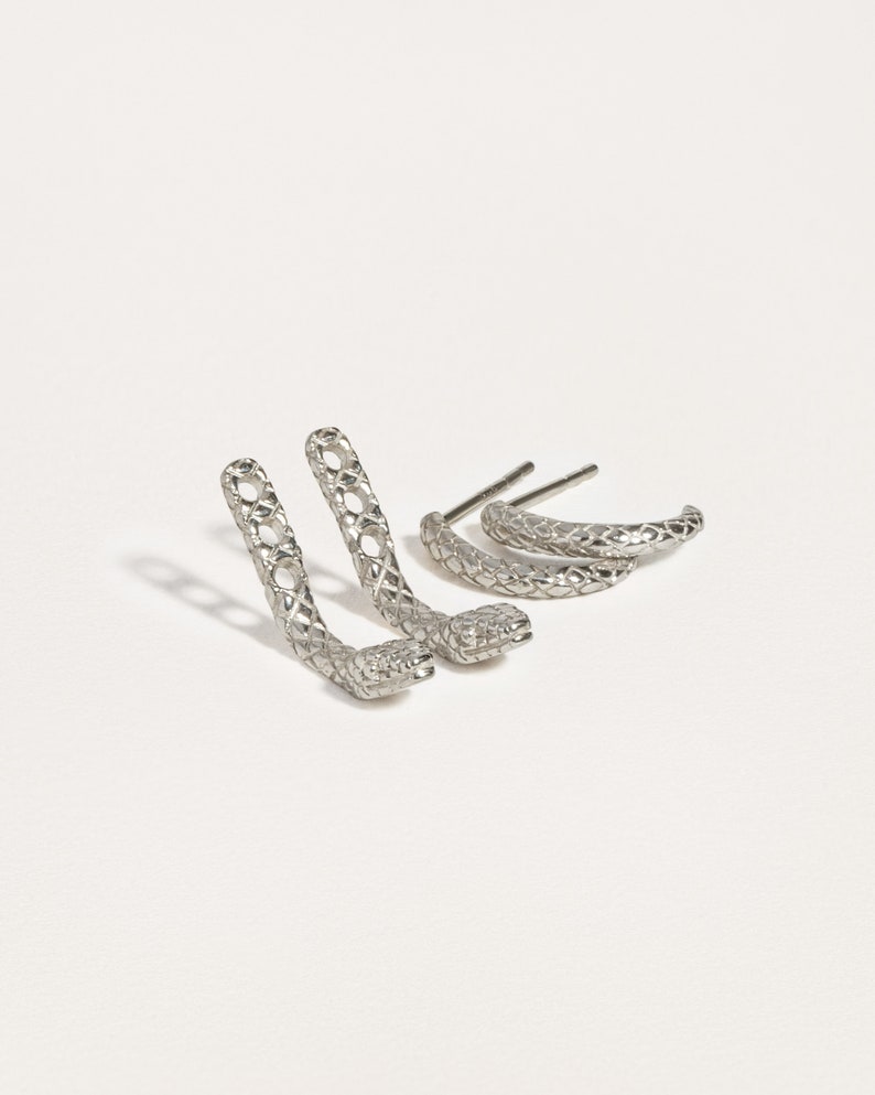 Snake ear jacket earrings in sterling silver, showcasing a polished and elegant design.