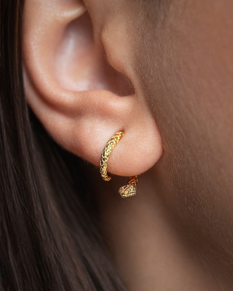 Female model showcasing snake ear jacket earrings in a polished 24K gold-plated finish.