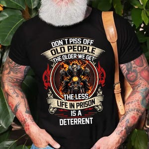 a person wearing a black t-shirt with a graphic design and text on it.