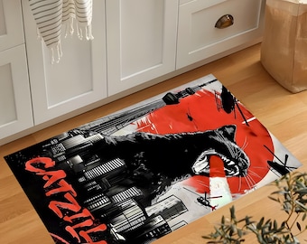 May include: A rectangular floor mat featuring a black cat roaring in front of a red sun, with a cityscape and helicopters. The word "CATZILLA" is written in red. The mat is designed for indoor use.