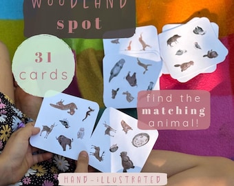 May include: A set of 31 square white cards titled Woodland Spot, featuring hand-illustrated woodland animals. The cards display various small animal drawings, including a lynx, bison, owl, and deer, designed for a matching game activity.