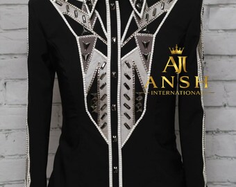 May include: A black long-sleeve shirt featuring a structured collar and a front panel decorated with white and grey geometric fabric overlays, silver-toned studs, and crystals. The text AJI ANSH INTERNATIONAL is printed in gold on the right side.