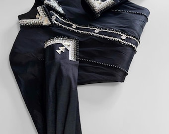 May include: A black long-sleeve button-down shirt featuring silver-toned crystal embellishments along the collar, the front placket, and the cuffs. The shirt is constructed from a smooth, dark fabric with a subtle sheen and structured lines.