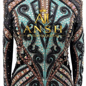 May include: A long-sleeved jacket featuring a black and turquoise color scheme with intricate black scrollwork embroidery, copper-toned accents, and numerous clear and iridescent crystals. The text AJ INTERNATIONAL with a crown icon is centered.