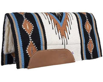 May include: A rectangular horse saddle pad featuring a woven pattern in black, white, tan, and blue. The pad has a thick white fleece lining on the underside and a brown leather wear patch on the side with a small embossed logo and stitching.
