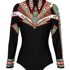May include: Black equestrian show shirt with long sleeves. The shirt features intricate embellishments in red, green, white, and gold. The collar and cuffs are also decorated with colorful accents. The shirt is hanging on a hanger.