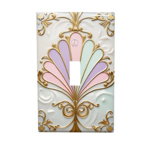 May include: A decorative light switch cover with a pastel fan design. The cover features a white background with gold filigree accents and a central fan shape in shades of pink, purple, and mint green.