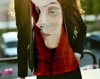 May include: A black jacket over a red and orange top with a painted face design. The top features a detailed illustration of a face with freckles and red hair. The person is wearing black pants.