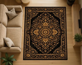 May include: A rectangular black area rug with an ornate gold floral pattern. The rug features a central medallion design and a detailed border. The rug is placed on a light wood floor, with a beige sofa and plants visible in the background.