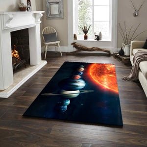 May include: Rectangular area rug featuring a vibrant depiction of the solar system. The design showcases planets stacked vertically, with a large, radiant sun on the right. The rug's color palette includes blues, oranges, and browns.
