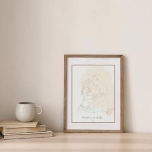 May include: A framed line art print featuring a couple embracing and kissing. The artwork is in a minimalist style with a neutral color palette. The print is in a wooden frame and includes the names "Anastasiia & Andrei" and the year 2023.