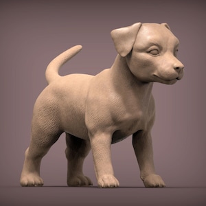 Puede incluir: Una escultura de color beige de un cachorro de pie, con la cola curvada hacia arriba. El cachorro tiene orejas caídas y mira hacia la derecha. La escultura es detallada, mostrando la textura del pelaje y los rasgos faciales del cachorro. El fondo es morado.