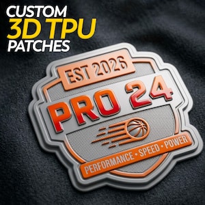 May include: A custom 3D TPU patch with a basketball theme. The patch is silver, orange, and red, with the text "PRO 24" and "EST 2026". The bottom of the patch reads "PERFORMANCE • SPEED • POWER".
