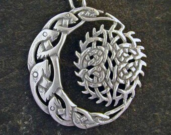 May include: A silver pendant necklace featuring a Celtic knot design with a crescent moon and a stylized tree within the knot.