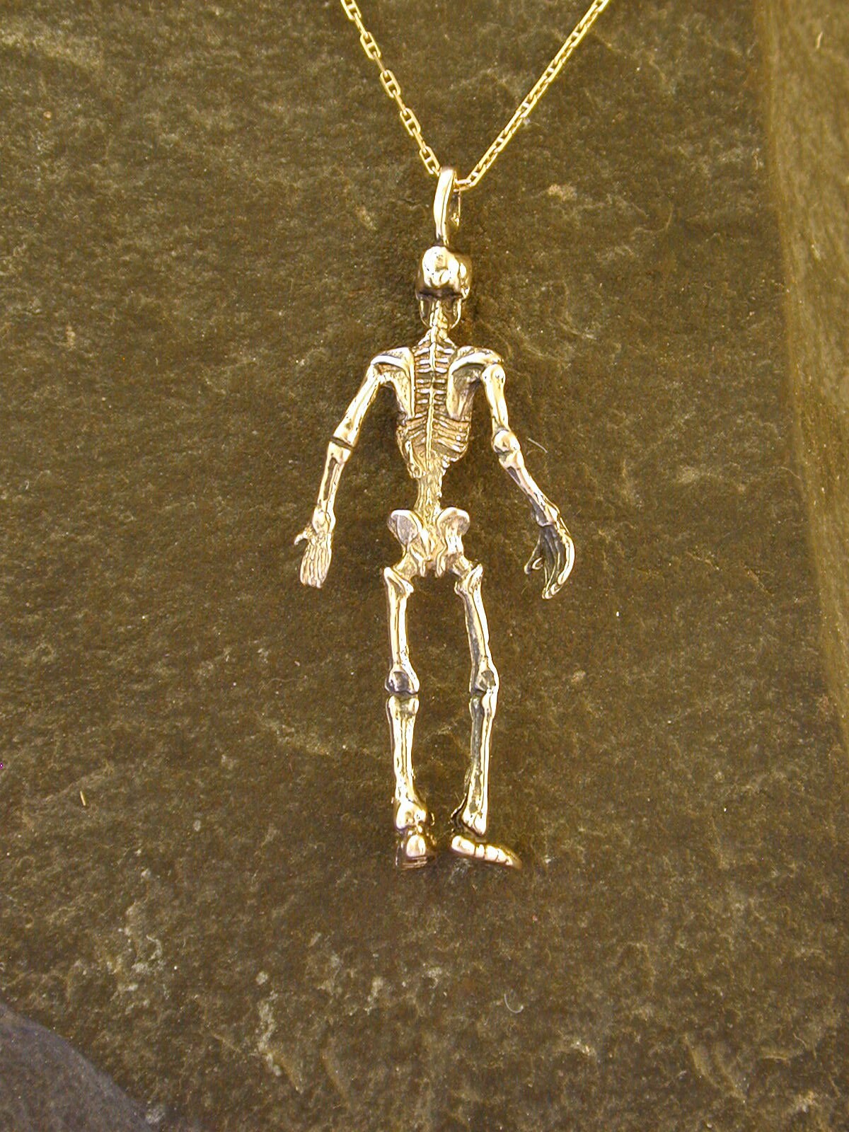 Gold skeleton best sale pendant