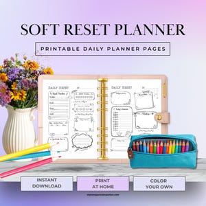 May include: A soft pink planner with gold rings and a teal pencil case filled with colored pencils. The planner includes daily reset pages with sections for mood tracking, water intake, and notes. Text reads "SOFT RESET PLANNER" and "PRINTABLE DAILY PLANNER PAGES."