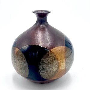 May include: A set of three ceramic mugs with a speckled, matte finish. The mugs are in shades of cream, light gray, and dark gray. Each mug has a simple, minimalist design and a rounded handle.