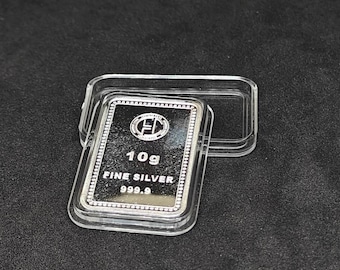 May include: A rectangular 10g fine silver bar, marked 999.9 purity, is displayed in a clear plastic case. The silver bar features a logo and is set against a dark background.