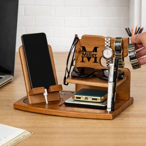 May include: A rustic wooden sign with the text "Welcome to our home" in white lettering. The sign has a distressed finish and a simple, inviting design, suitable for a front porch or entryway.