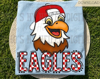 May include: A light blue t-shirt featuring a cartoon eagle head wearing a red baseball cap, positioned above the word EAGLES in a red and white checkered pattern. The text INSTANT DOWNLOAD is visible in the upper right corner of the image.