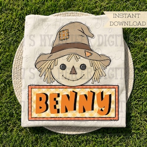May include: A cream-colored t-shirt featuring a graphic of a scarecrow head wearing a tan hat with patches, straw hair, and a stitched smile. Below the scarecrow is an orange rectangular sign with the name BENNY in bold black letters. Text reads INSTANT DOWNLOAD.