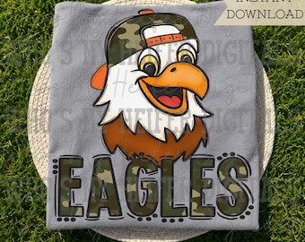 May include: A gray t-shirt featuring a cartoon eagle head wearing a camouflage baseball cap, with the word EAGLES printed below in a matching camouflage pattern. The text INSTANT DOWNLOAD is visible in the upper right corner of the image.
