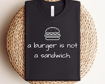 Una hamburguesa no es un sándwich. Camiseta divertida con mensaje sobre comida.