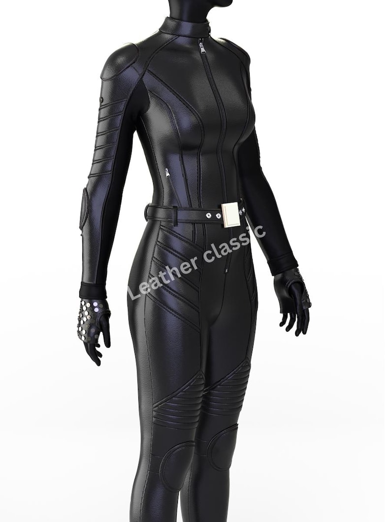 May include: Black leather jumpsuit with a high collar and a front zipper. The suit features quilted detailing on the shoulders, arms, and legs, along with a belt and gloves. The text "Leather classic" is visible on the garment.