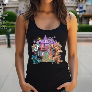 May include: Black tank top featuring a colorful graphic with the text "Epic Universe" and cartoon characters. The tank top is sleeveless and has a scoop neck.