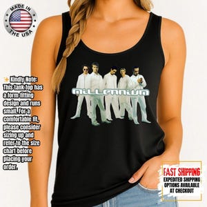 May include: Black tank top featuring the word "Millennium" in white block letters above a group of men in white outfits. The tank top has a round neckline and is made in the USA.