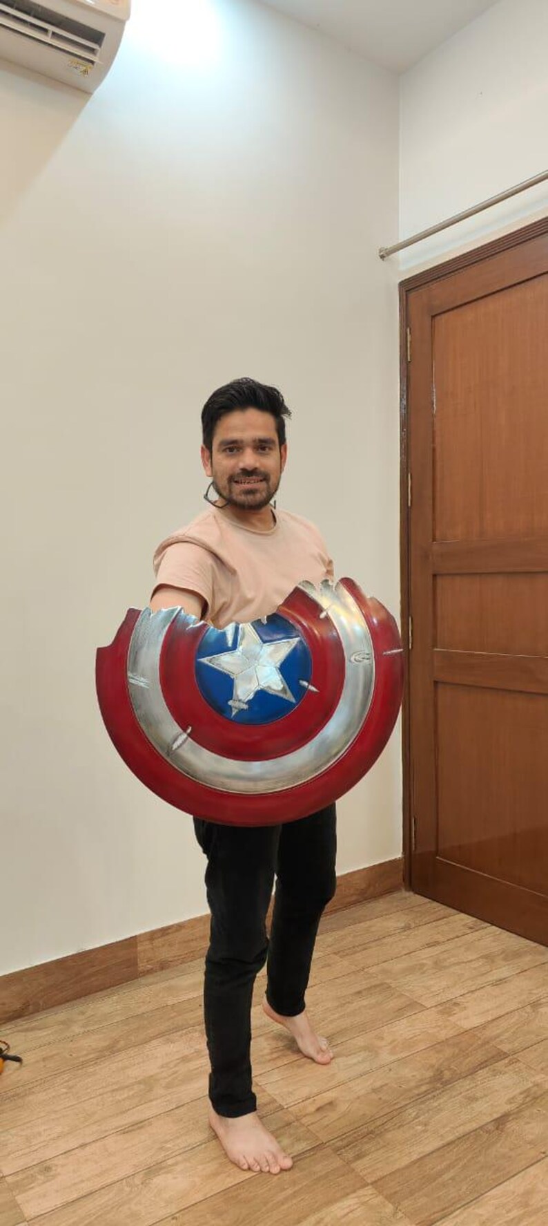 May include: A Captain America shield prop, featuring a red, white, and blue color scheme. The shield has a star in the center and a silver metallic rim. The shield is approximately 24 inches in diameter.