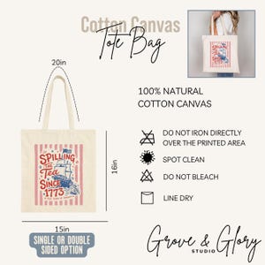 May include: Cream-colored cotton canvas tote bag with a patriotic design. The bag features a red and white striped background with a graphic of a ship and the text "Spilling the Tea Since 1773". The bag is 16 inches tall and 15 inches wide.