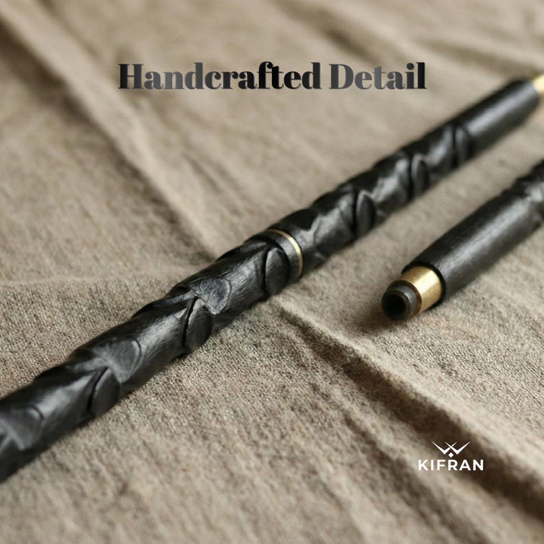May include: A black, handcrafted pen with intricate carved details and gold-colored accents. The pen is shown in two pieces, with the tip detached. The text "Handcrafted Detail" is at the top, and the logo "KIFRAN" is at the bottom.