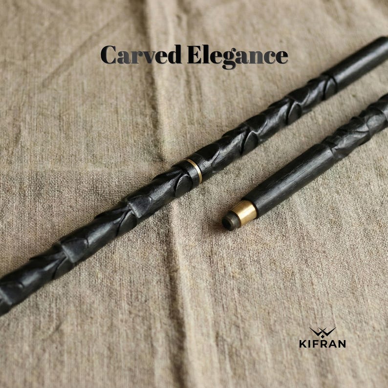 May include: Two black, carved wooden wands with gold-colored accents. The wands have intricate, textured designs and are displayed on a neutral-toned fabric. The text "Carved Elegance" is at the top.