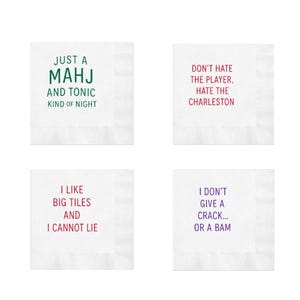 May include: Four white cocktail napkins with humorous phrases printed in various colors. The phrases include "JUST A MAHJ AND TONIC KIND OF NIGHT," "DON'T HATE THE PLAYER, HATE THE CHARLESTON," "I LIKE BIG TILES AND I CANNOT LIE," and "I DON'T GIVE A CRACK... OR A BAM."