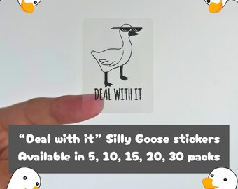 May include: A clear sticker with a cartoon goose wearing sunglasses and the text "DEAL WITH IT". The sticker is held by a hand. The text "Deal with it" Silly Goose stickers is also visible.