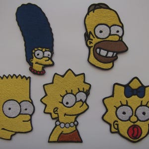 May include: Embroidered patches of characters from The Simpsons cartoon series. The patches depict Marge, Homer, Bart, Lisa, and Maggie Simpson. Each patch is yellow with black, white, and other colour accents.