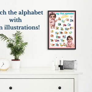 May include: A framed alphabet chart with illustrations and the text "my first alphabet" is displayed on a white wall. The chart features colorful letters, images, and two baby illustrations. The words "Teach the alphabet with fun illustrations!" are above a plant and clock.