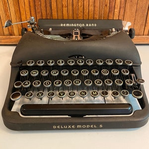 Remington Rand Deluxe Model 5 portable manual typewriter & case Works! Could use detail cleaning/fine tuning. Great machine from the 1940s